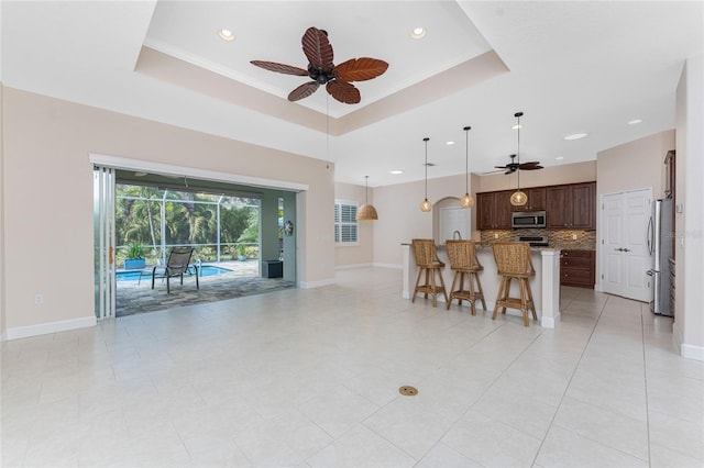 interior space with a tray ceiling and ceiling fan