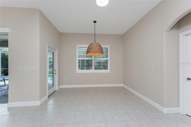 unfurnished dining area featuring plenty of natural light and light tile patterned flooring