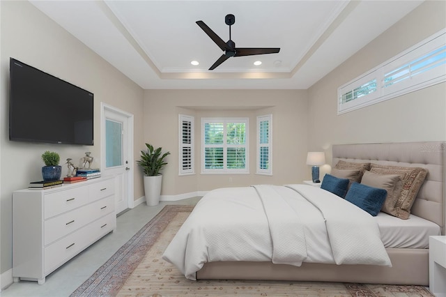 bedroom featuring ceiling fan, ornamental molding, and a raised ceiling