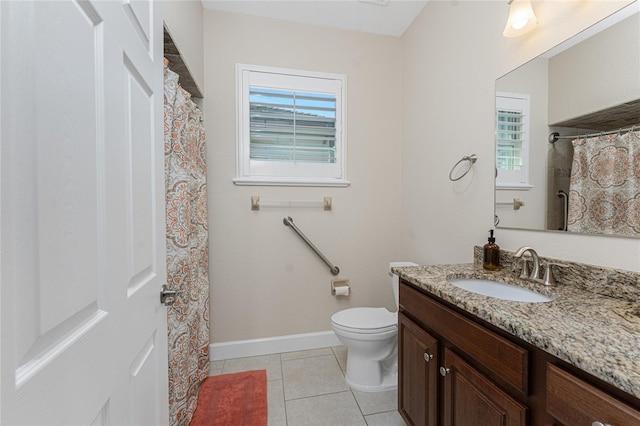 bathroom with tile patterned floors, toilet, vanity, and plenty of natural light