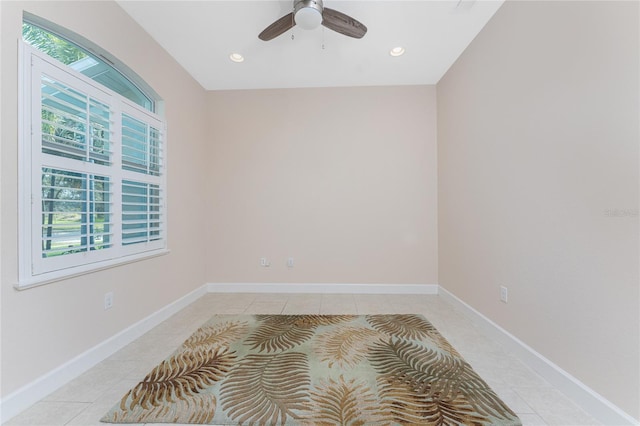 spare room featuring light tile patterned floors and ceiling fan