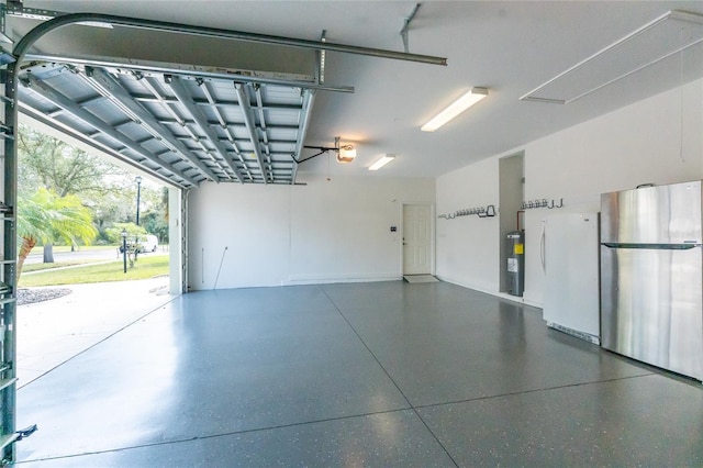 garage featuring a garage door opener, stainless steel fridge, electric water heater, and white fridge