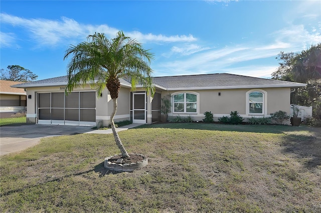 single story home featuring a garage and a front yard