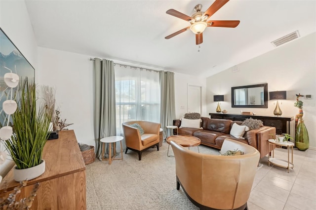 tiled living room with lofted ceiling and ceiling fan