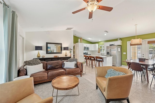 tiled living room with lofted ceiling, ceiling fan, and french doors