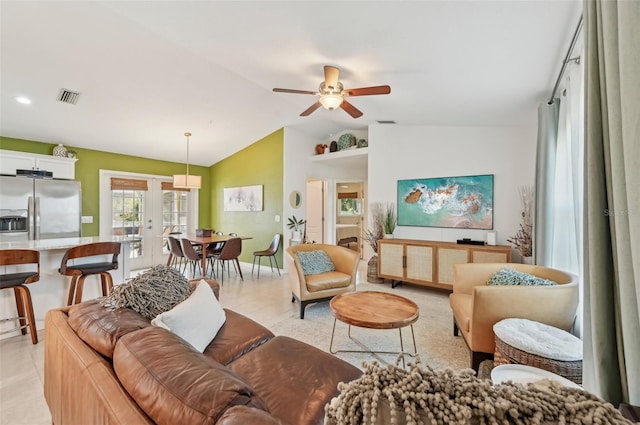 tiled living room featuring lofted ceiling, ceiling fan, and french doors