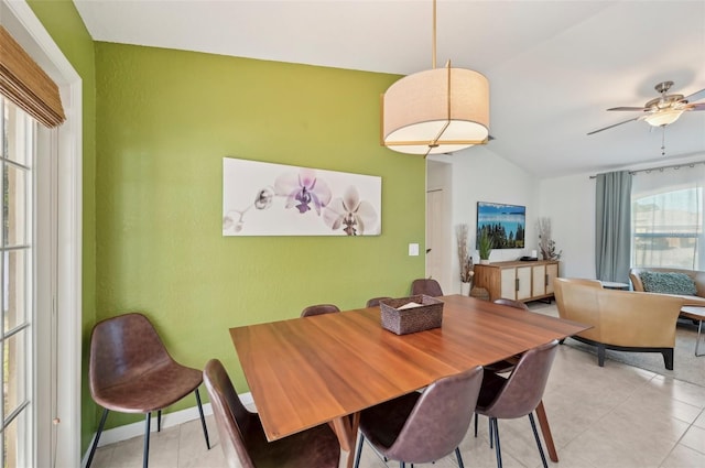 tiled dining room featuring vaulted ceiling and ceiling fan