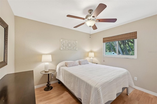 bedroom with ceiling fan and light wood-type flooring