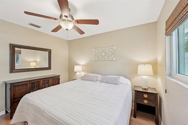 bedroom with ceiling fan and light hardwood / wood-style floors