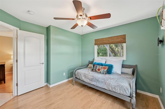 bedroom with light hardwood / wood-style floors and ceiling fan