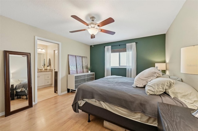 bedroom with ceiling fan, light hardwood / wood-style floors, and ensuite bath