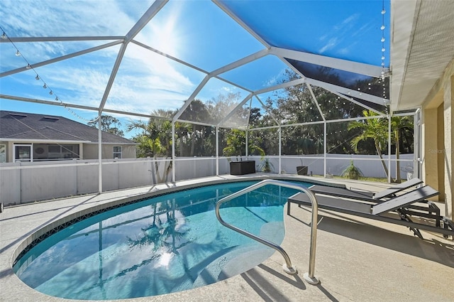 view of swimming pool featuring a patio and a lanai