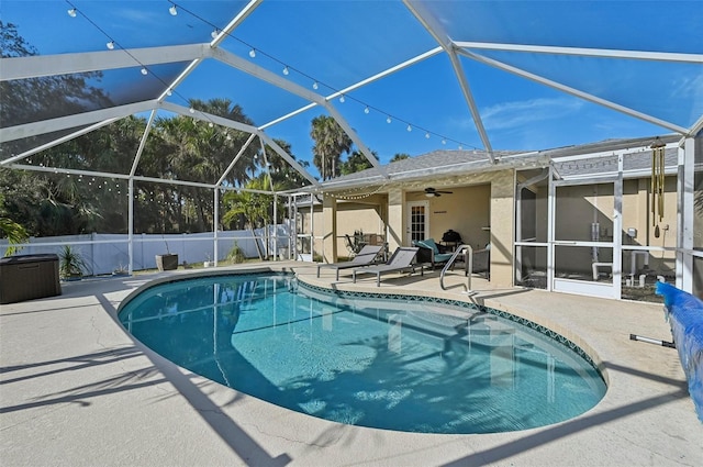 view of swimming pool featuring a lanai, a patio, and ceiling fan