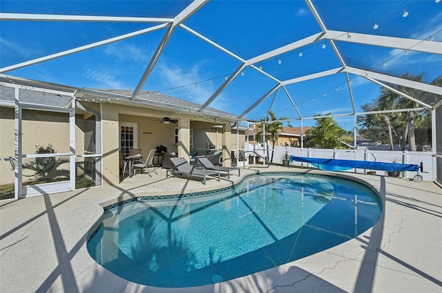 view of pool with a patio, a lanai, and ceiling fan