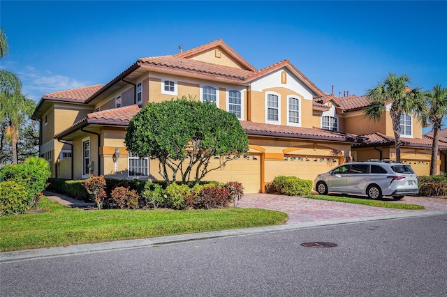 mediterranean / spanish-style house with a garage