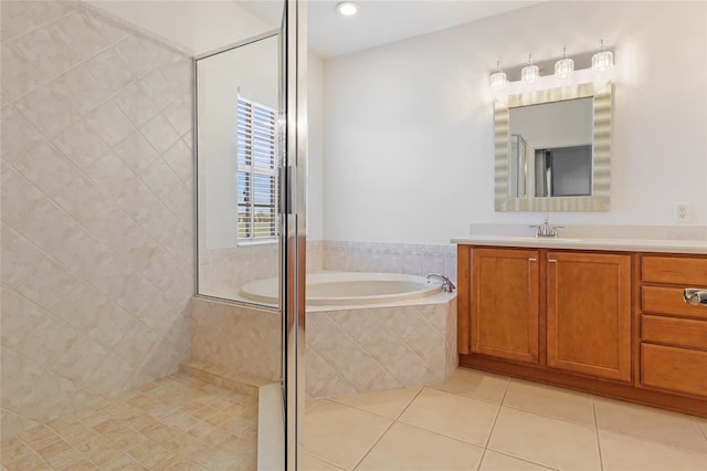 bathroom with tile patterned floors, shower with separate bathtub, and vanity