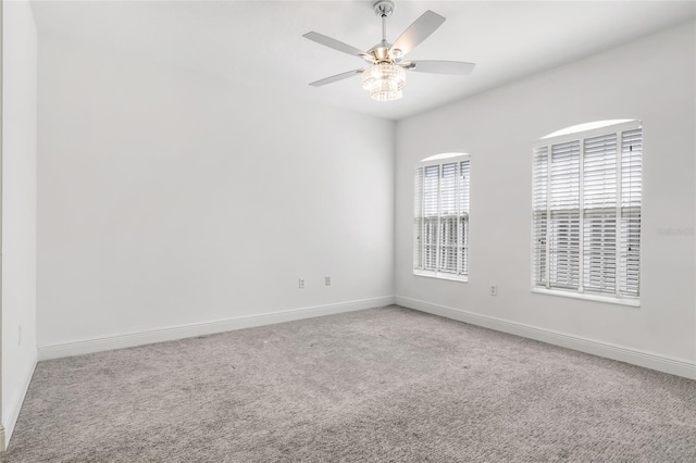 carpeted empty room with ceiling fan