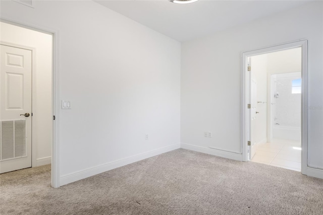 unfurnished room featuring light carpet