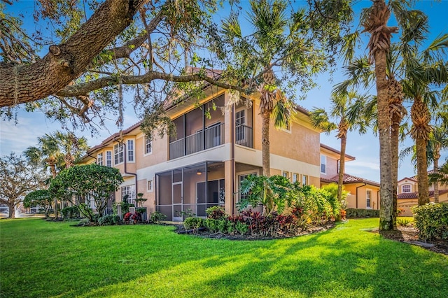 rear view of property with a yard