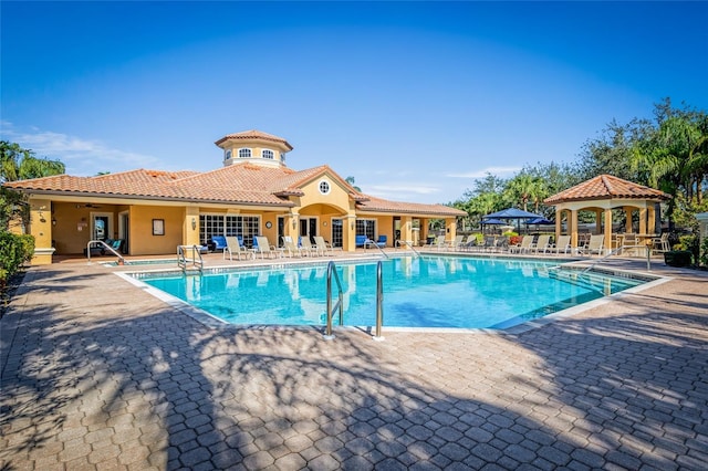 view of swimming pool with a gazebo and a patio area