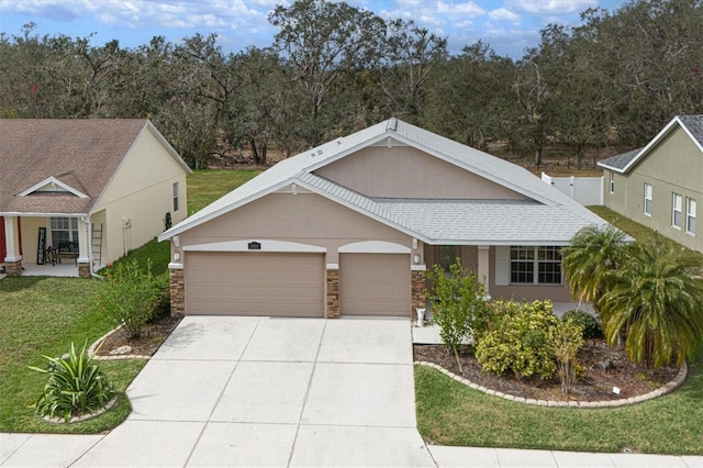 view of front of property with a garage and a front yard