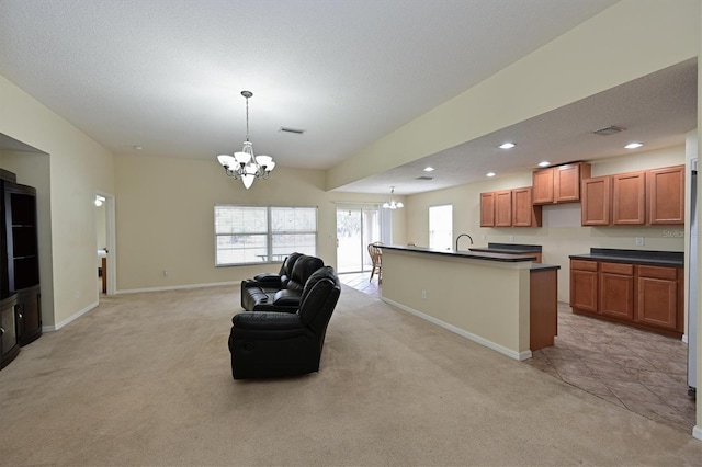 kitchen with light carpet, an inviting chandelier, and decorative light fixtures