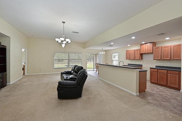 kitchen featuring an inviting chandelier, hanging light fixtures, and light carpet