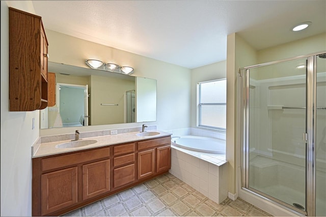 bathroom featuring vanity and separate shower and tub