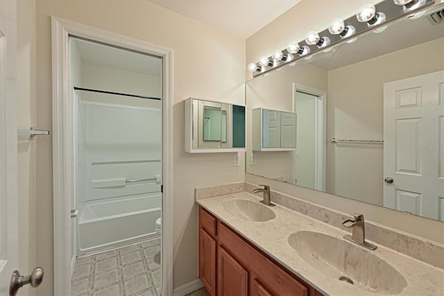 full bathroom featuring bathtub / shower combination, vanity, and toilet