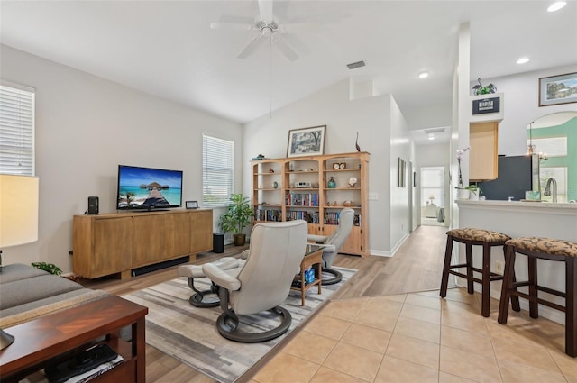 tiled living room with sink, vaulted ceiling, and ceiling fan