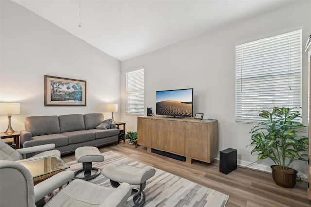 living room with vaulted ceiling and light hardwood / wood-style floors