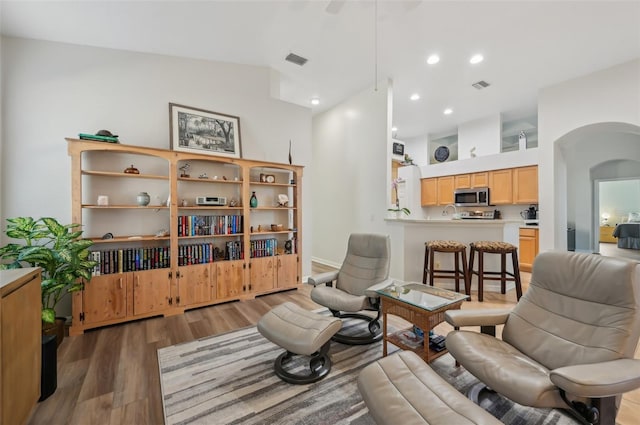 living room featuring dark wood-type flooring and lofted ceiling