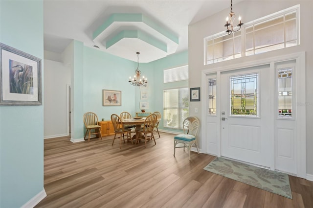 entryway featuring hardwood / wood-style flooring and an inviting chandelier