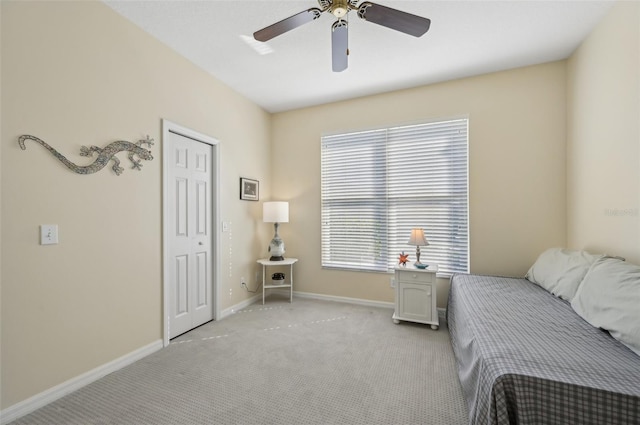 bedroom featuring multiple windows, ceiling fan, and light carpet