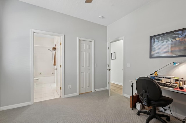 home office with ceiling fan and light carpet