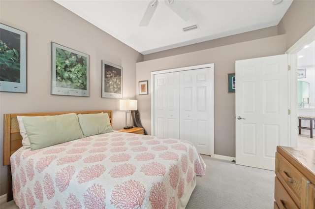 carpeted bedroom featuring ceiling fan and a closet