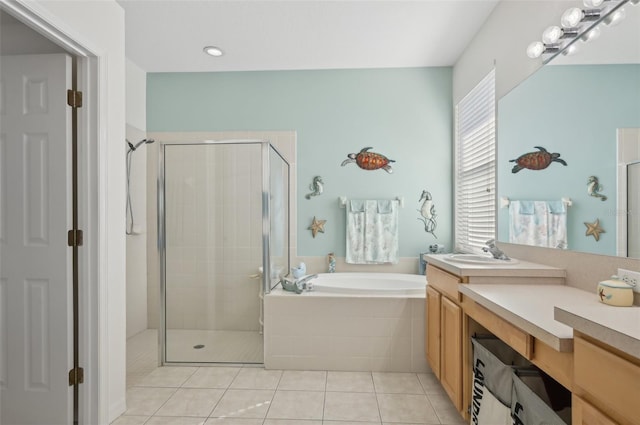 bathroom with tile patterned flooring, vanity, and separate shower and tub