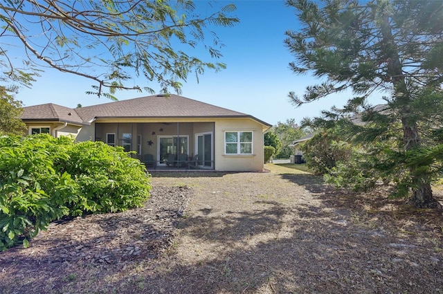 rear view of house featuring a sunroom