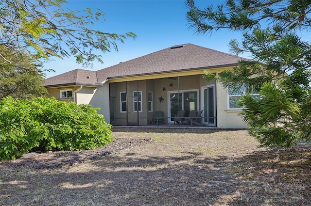 rear view of property with a sunroom