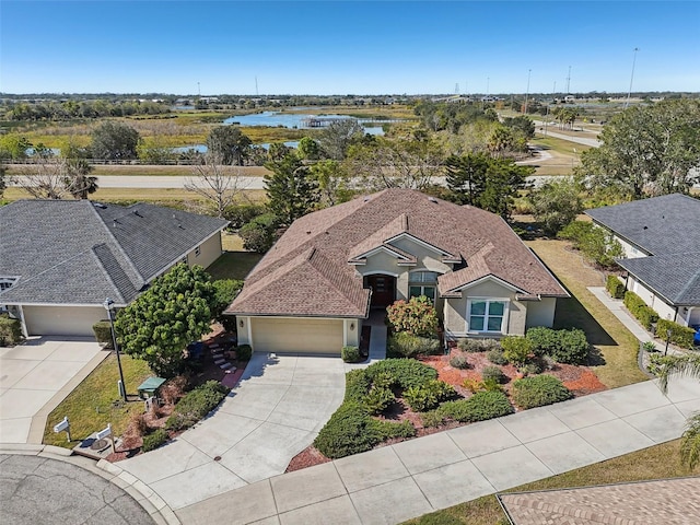 birds eye view of property with a water view