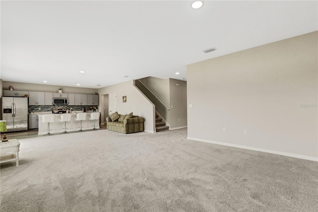 unfurnished living room featuring light colored carpet