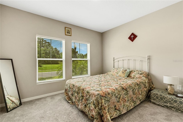 bedroom featuring light carpet