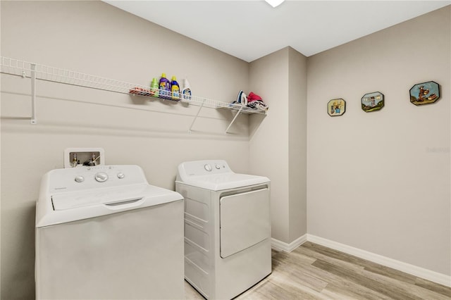 washroom with light hardwood / wood-style flooring and independent washer and dryer