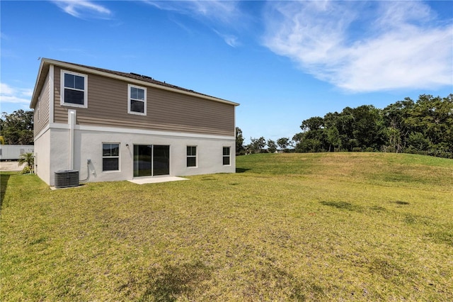 rear view of house featuring a yard and central AC unit