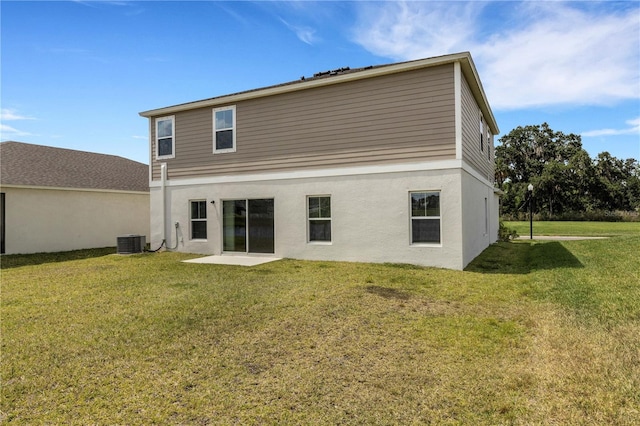 rear view of house with a yard, a patio area, and central air condition unit