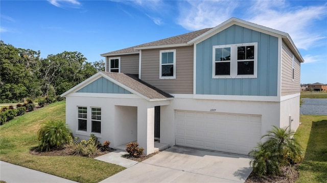 view of front of property featuring a garage and a front lawn