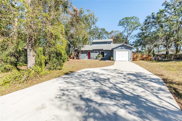 view of front facade with a garage and a front lawn