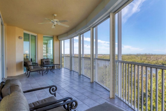 sunroom featuring ceiling fan