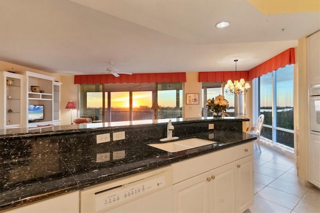 kitchen with pendant lighting, white cabinetry, sink, light tile patterned floors, and white appliances