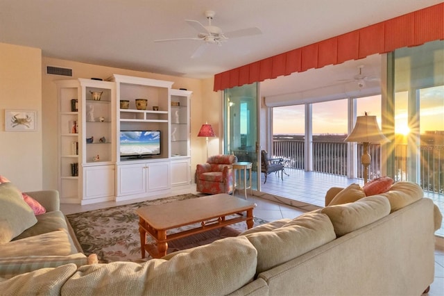 living room with light tile patterned floors and ceiling fan